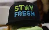 A black cap with the words "STAY FRESH" in bright colors, symbolizes a new beginning and the opportunity to join a dynamic Refresh Exteriors team.